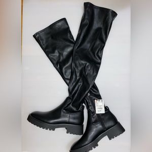 Knee high flat boots.